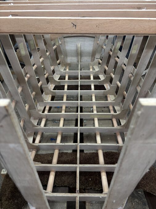The finished boat skeleton with no outer planking, showing gaps between the ribs