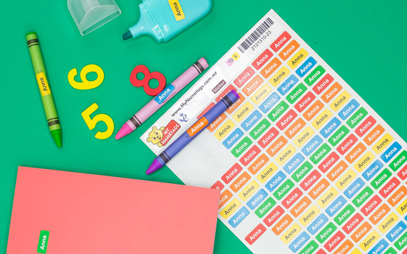 personalised ministickers stickers for pencils, pens, crayons and other school supplies, on a green background